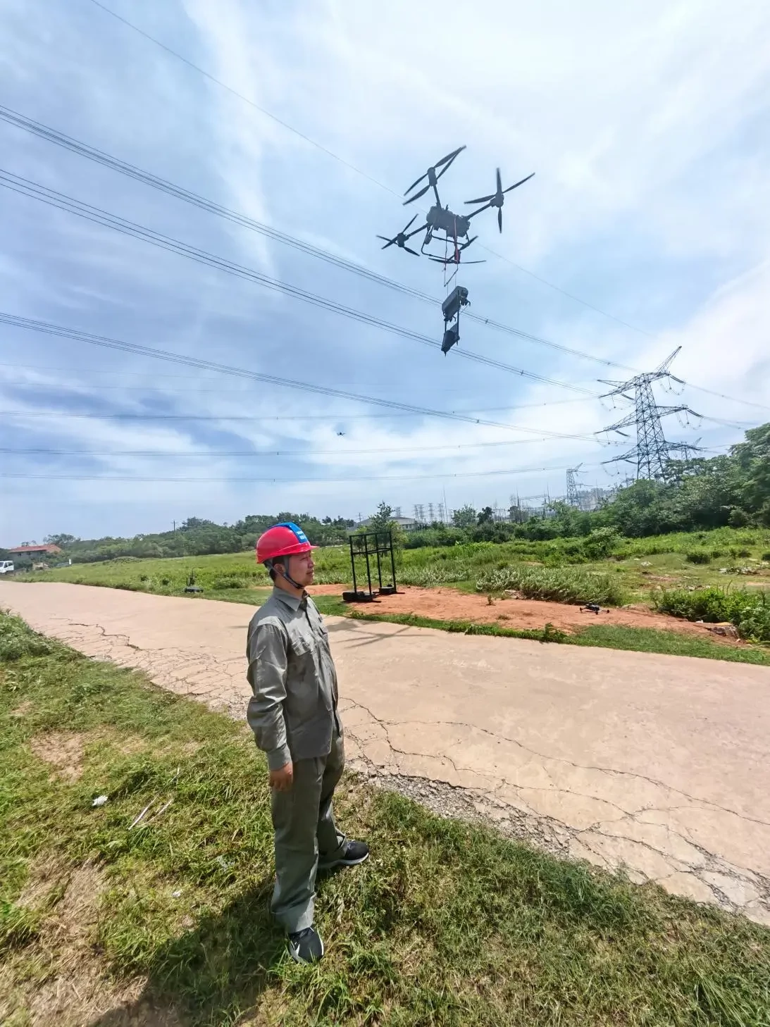 Power workers use drones to inspect power lines
